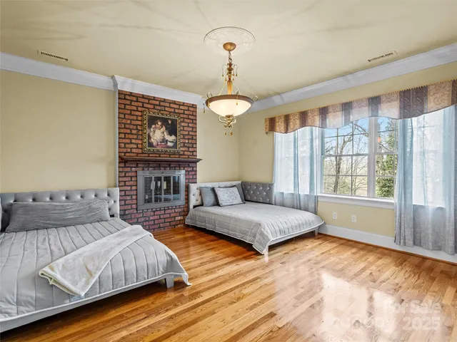 a spacious bedroom with a bed and a large window