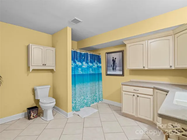 a bathroom with a sink a toilet and a mirror