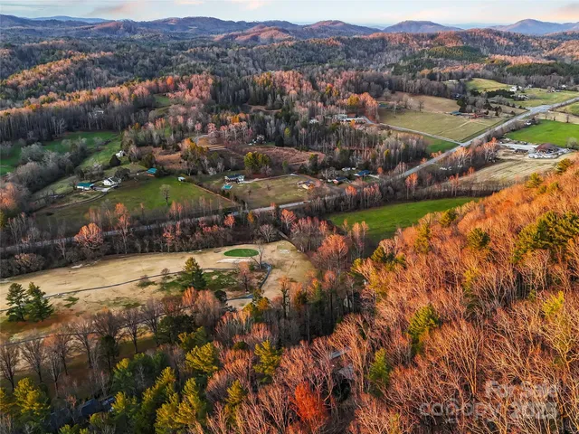 an aerial view of residential houses with outdoor space and river