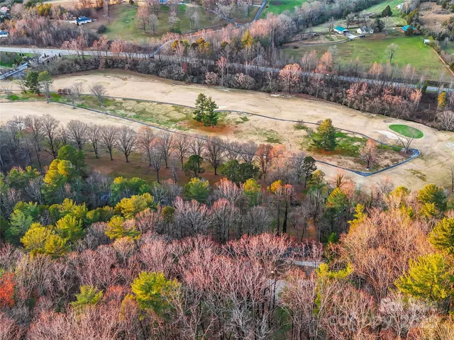 a street view with residential house and green space