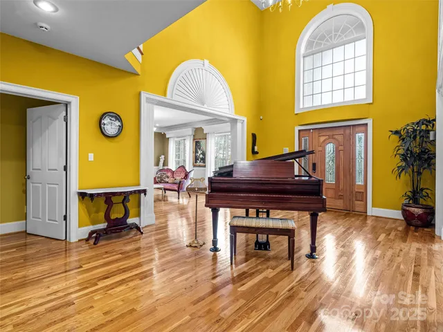 a living room with fireplace furniture and a wooden floor