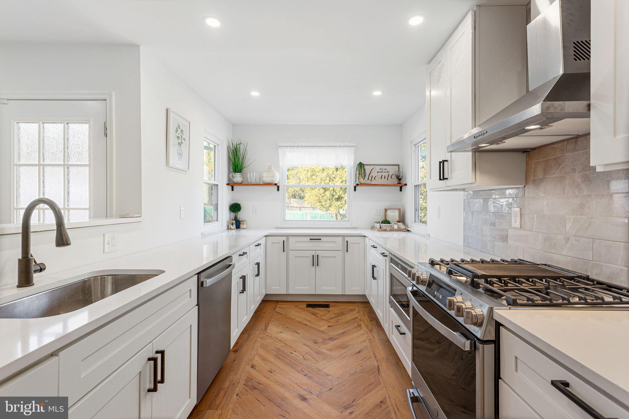 15162 Wayside Road Philadelphia, PA 19116 - Photo 10 of 34 a kitchen with granite countertop a sink stove and cabinets
