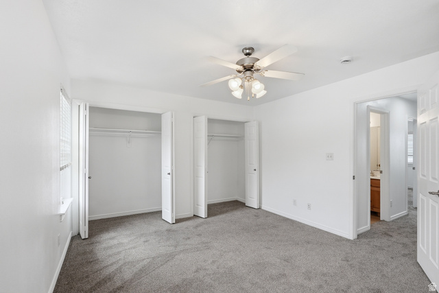 793 North 150 E Street Springville, UT 84663 - Photo 12 of 26 Spacious room featuring neutral carpeting, two double-door closets with shelving, a ceiling fan with integrated lighting, and a window with blinds