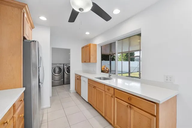 a kitchen with stainless steel appliances granite countertop a refrigerator and a sink