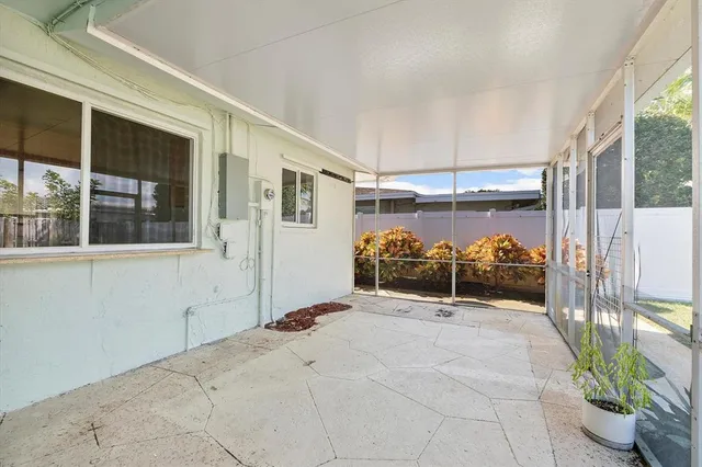a view of a porch with a table and chairs