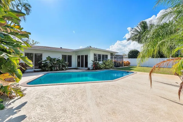 a view of house with swimming pool outdoor seating