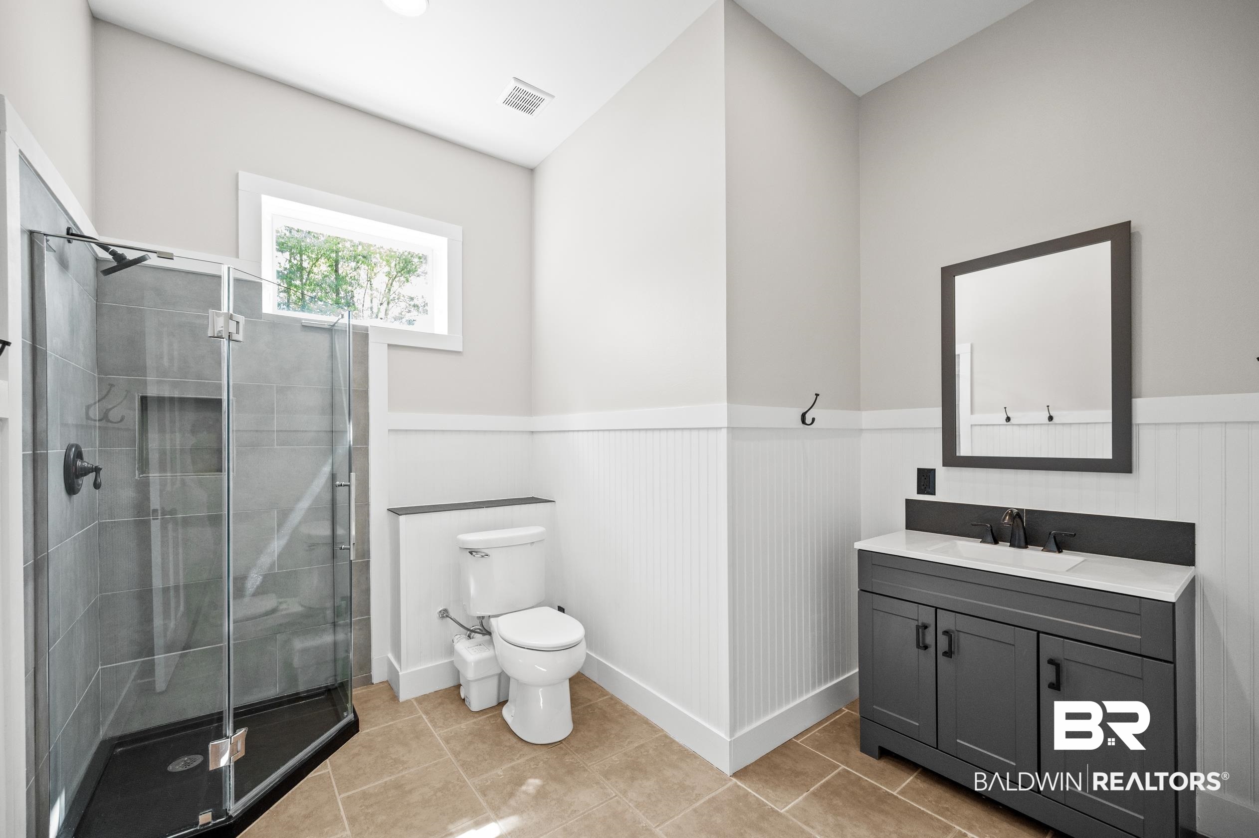15031 Timber Ridge Drive Loxley, AL 36551 - Photo 30 of 43 Bathroom with a shower with shower door, vanity, tile patterned floors, and toilet
