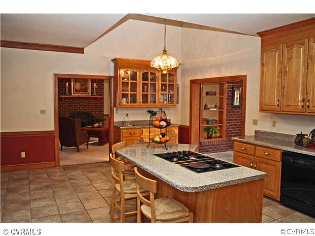 12904 Rockridge Road Chester, VA 23831 - Photo 8 of 12 a kitchen with a stove a refrigerator and a dining table