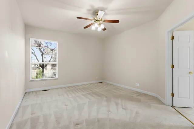 a spacious bathroom with a tub sink and mirror