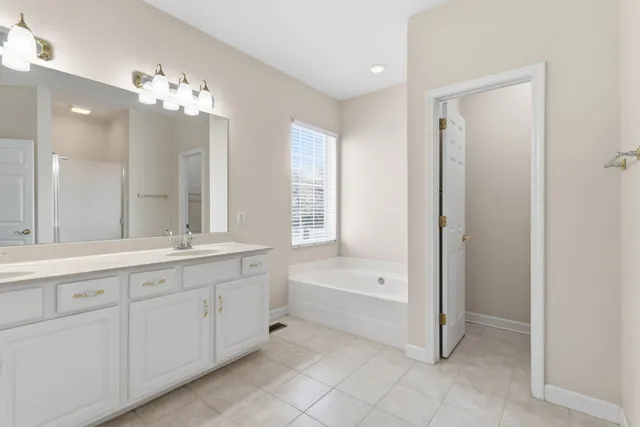 a spacious bathroom with a double vanity sink mirror and shower