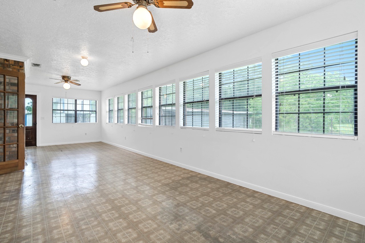 13180 Morgan Drive Splendora, TX 77372 - Photo 16 of 38 So many windows allowing the natural light to shine through. Door to the left leads to the living room. Door straight back leads to outside on the side of the home.