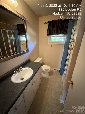 a bathroom with a sink a toilet and mirror