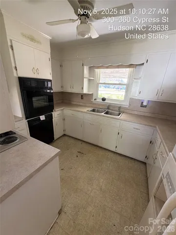 a kitchen that has a sink and a stove in it