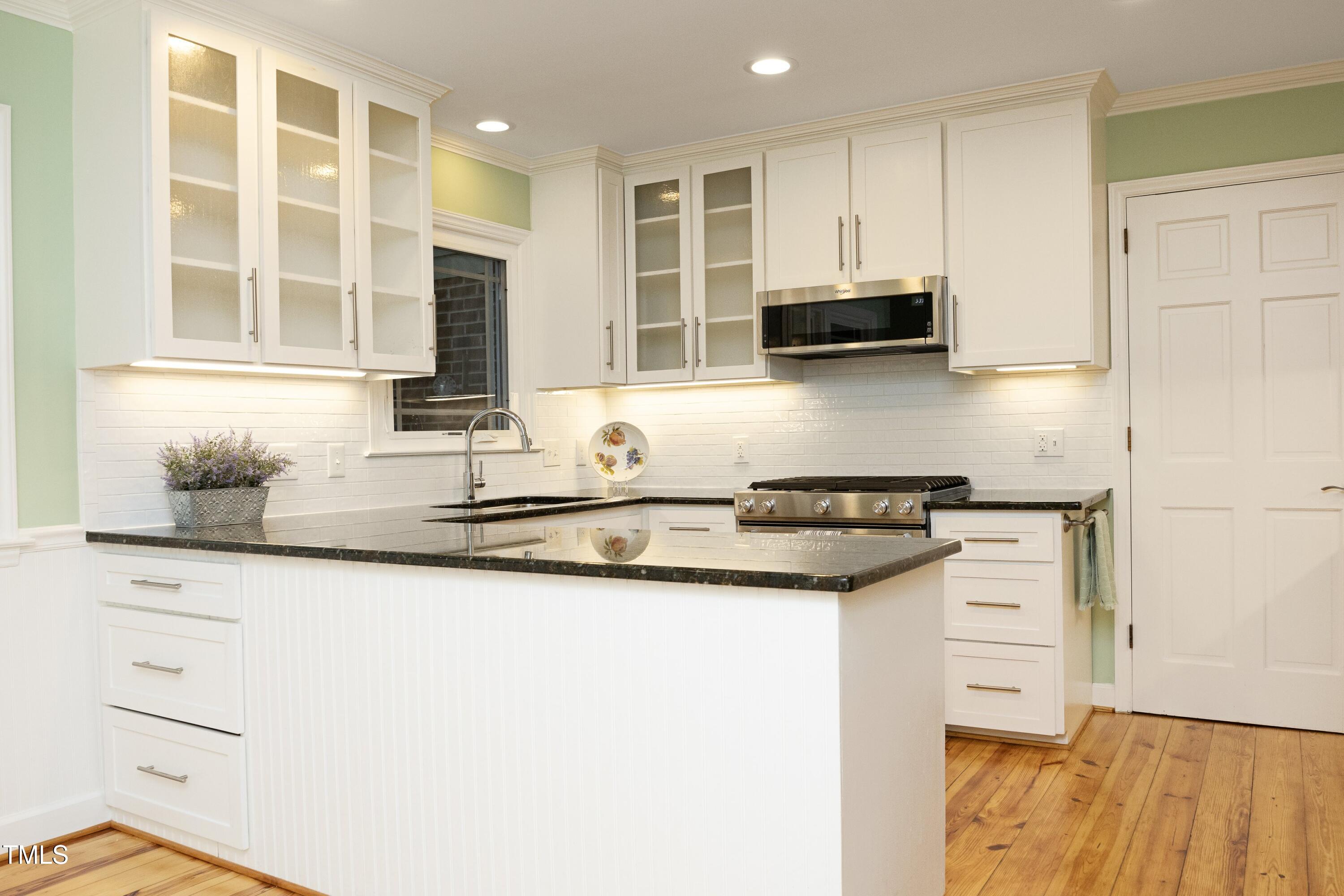 4616 Oak Park Road Raleigh, NC 27612 - Photo 16 of 63 Custom gourmet kitchen with granite countertops & glass front cabinets