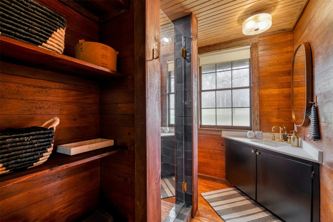 317 Walnut Creek Road Bastrop, TX 78602 - Photo 14 of 33 a bathroom with a sink and a large mirror