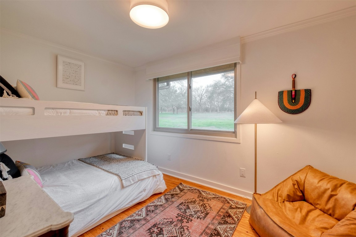 317 Walnut Creek Road Bastrop, TX 78602 - Photo 18 of 33 a bedroom with a bed and a window
