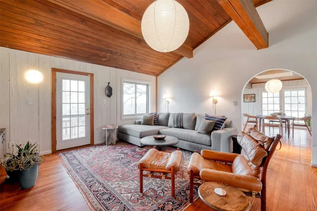 a living room with furniture and wooden floor