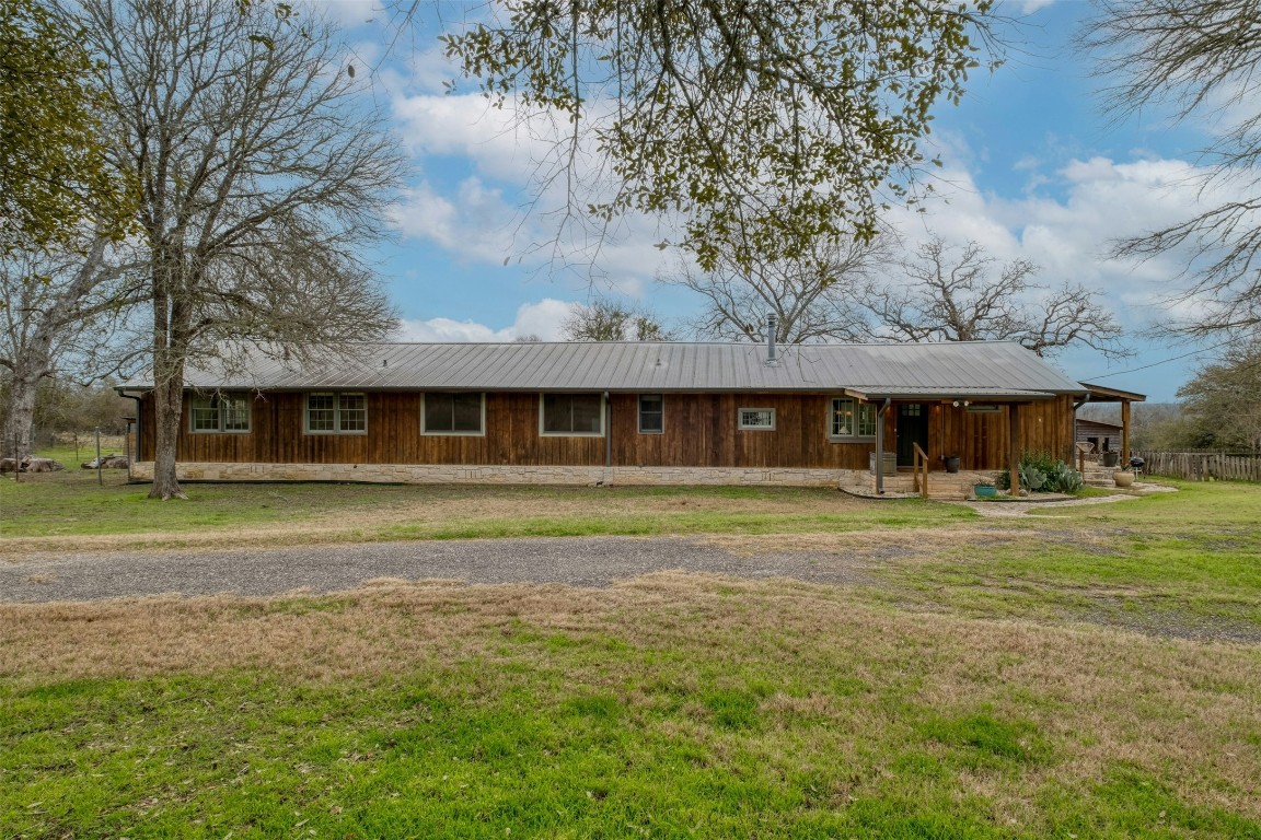 317 Walnut Creek Road Bastrop, TX 78602 - Photo 24 of 33 a front view of a house with a garden