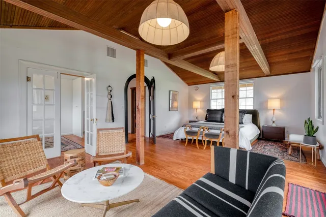 a living room with furniture a dining table and chairs