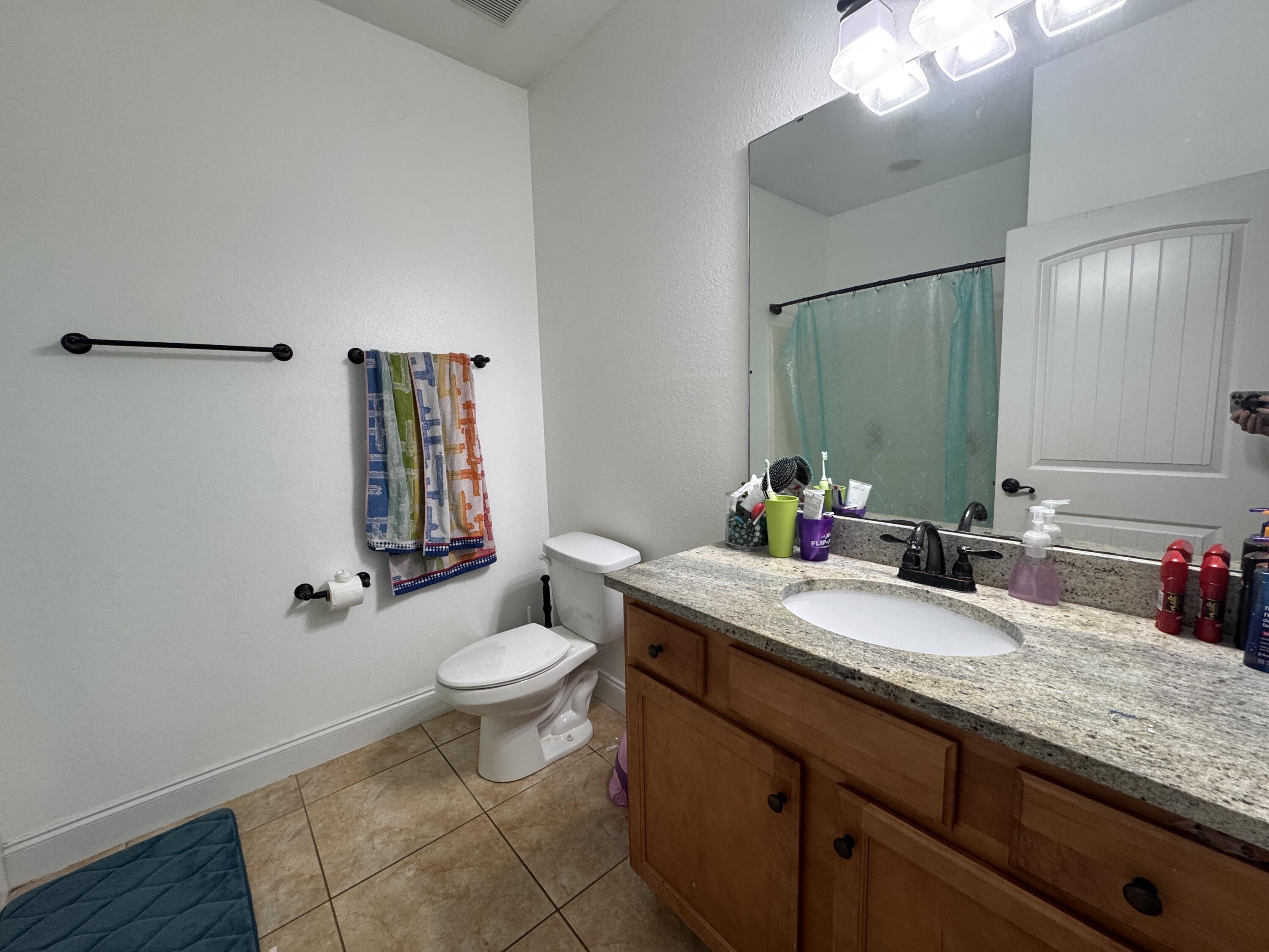 4413 Mirada Way Crestview, FL 32539 - Photo 19 of 27 a bathroom with a granite countertop sink a toilet and a mirror