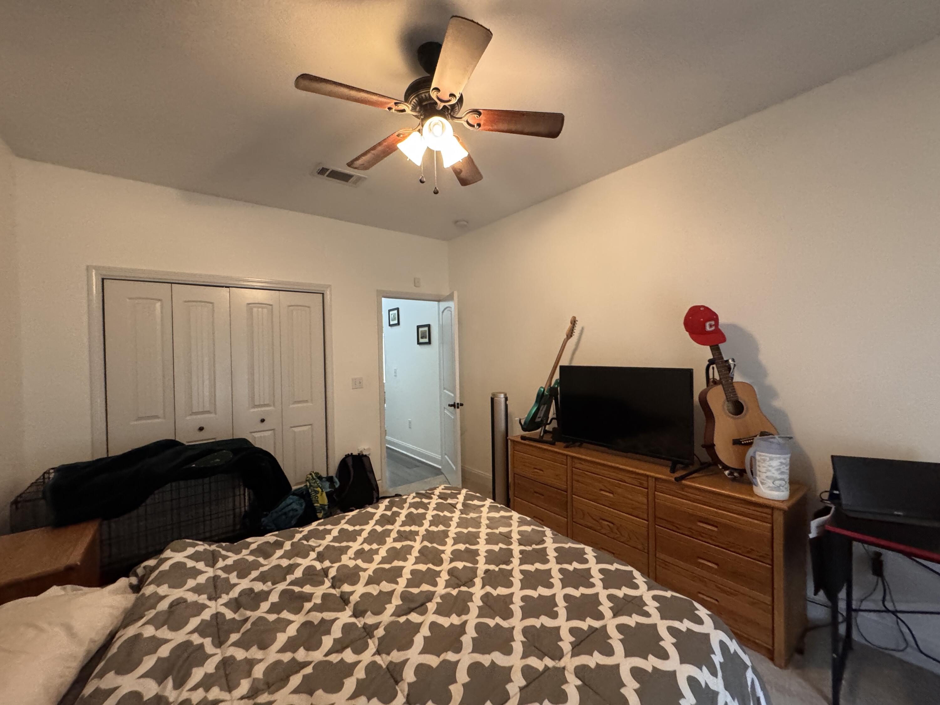 4413 Mirada Way Crestview, FL 32539 - Photo 21 of 27 a bedroom with a bed and a chandelier