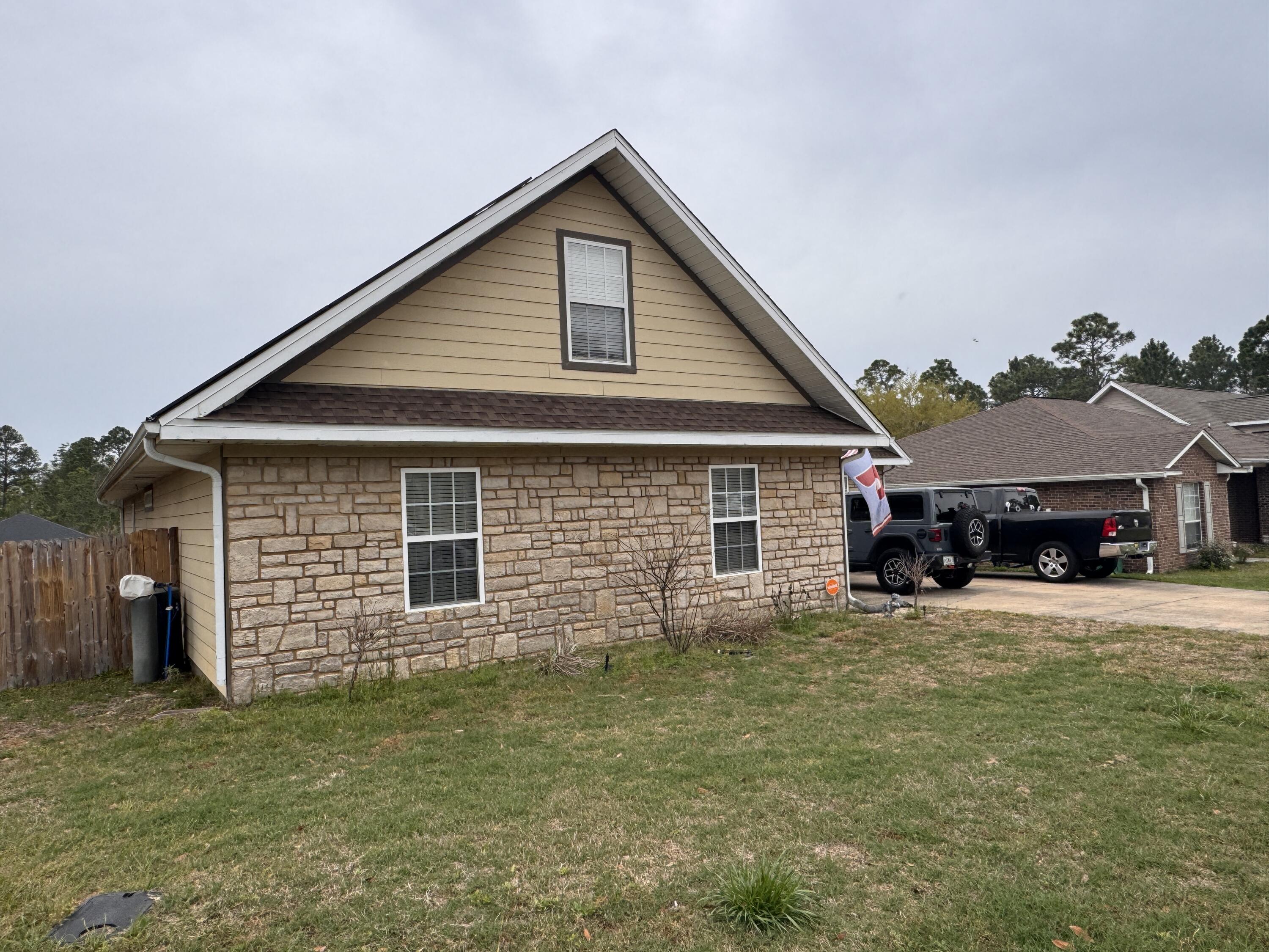 4413 Mirada Way Crestview, FL 32539 - Photo 27 of 27 a front view of a house with a yard and garage