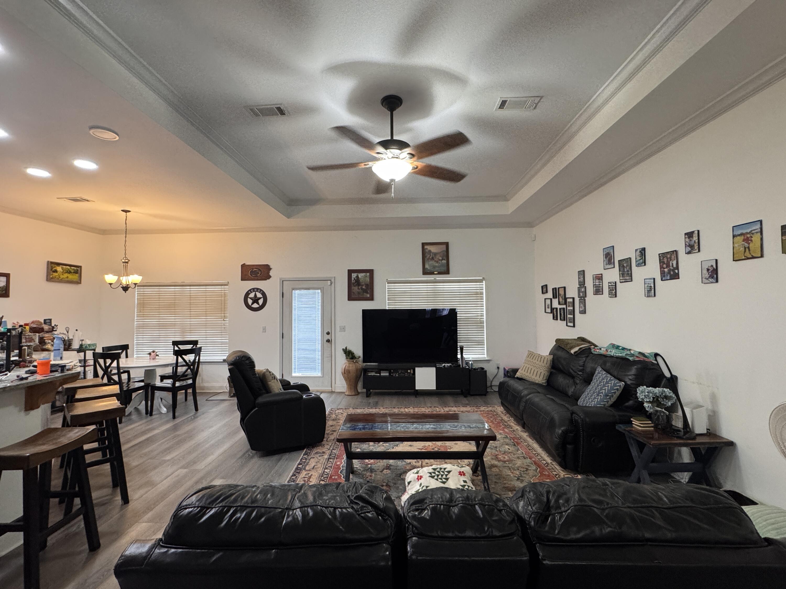 4413 Mirada Way Crestview, FL 32539 - Photo 3 of 27 a living room with furniture a flat screen tv and a fireplace