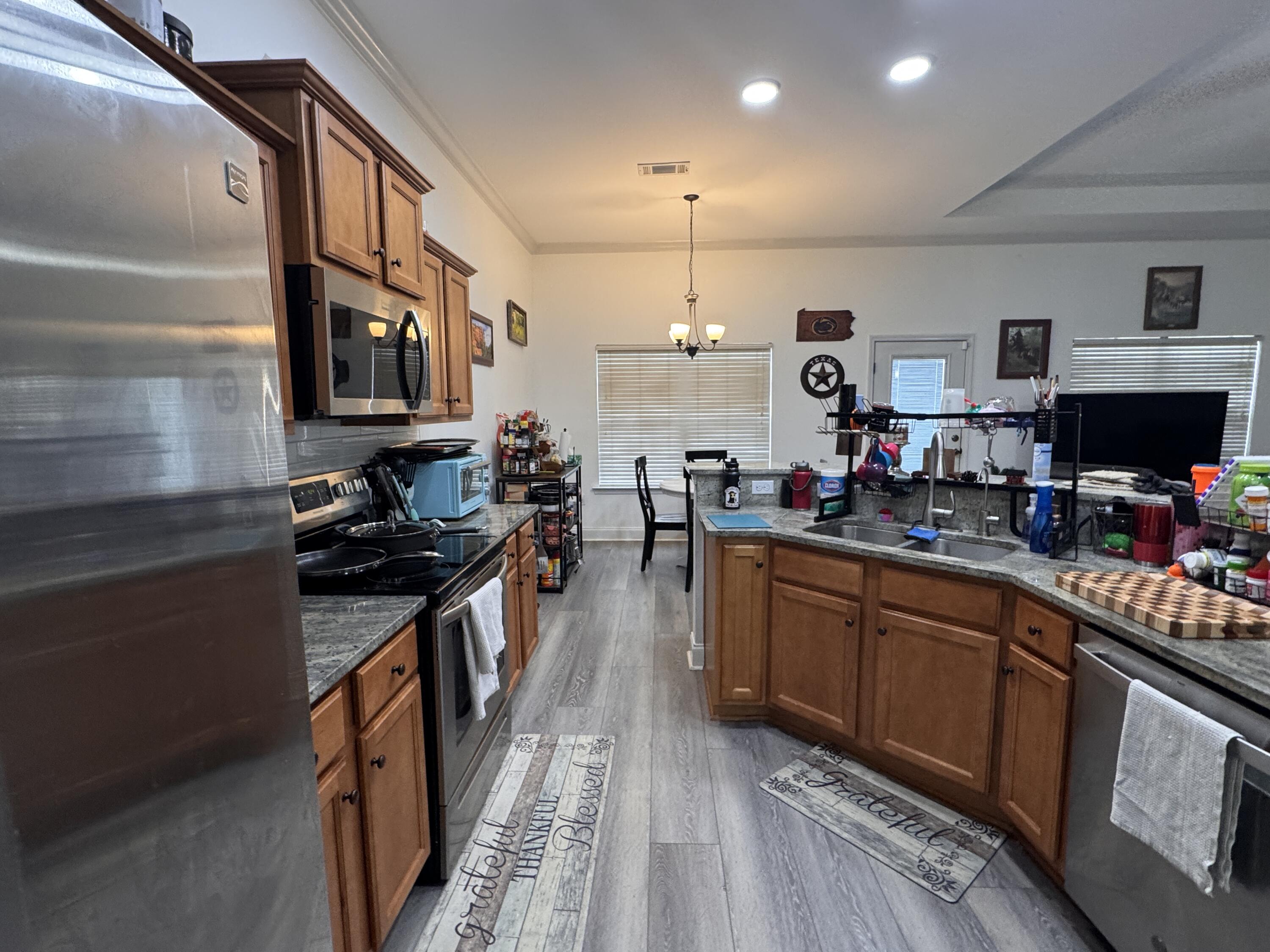 4413 Mirada Way Crestview, FL 32539 - Photo 8 of 27 a kitchen with stainless steel appliances granite countertop a stove and cabinets