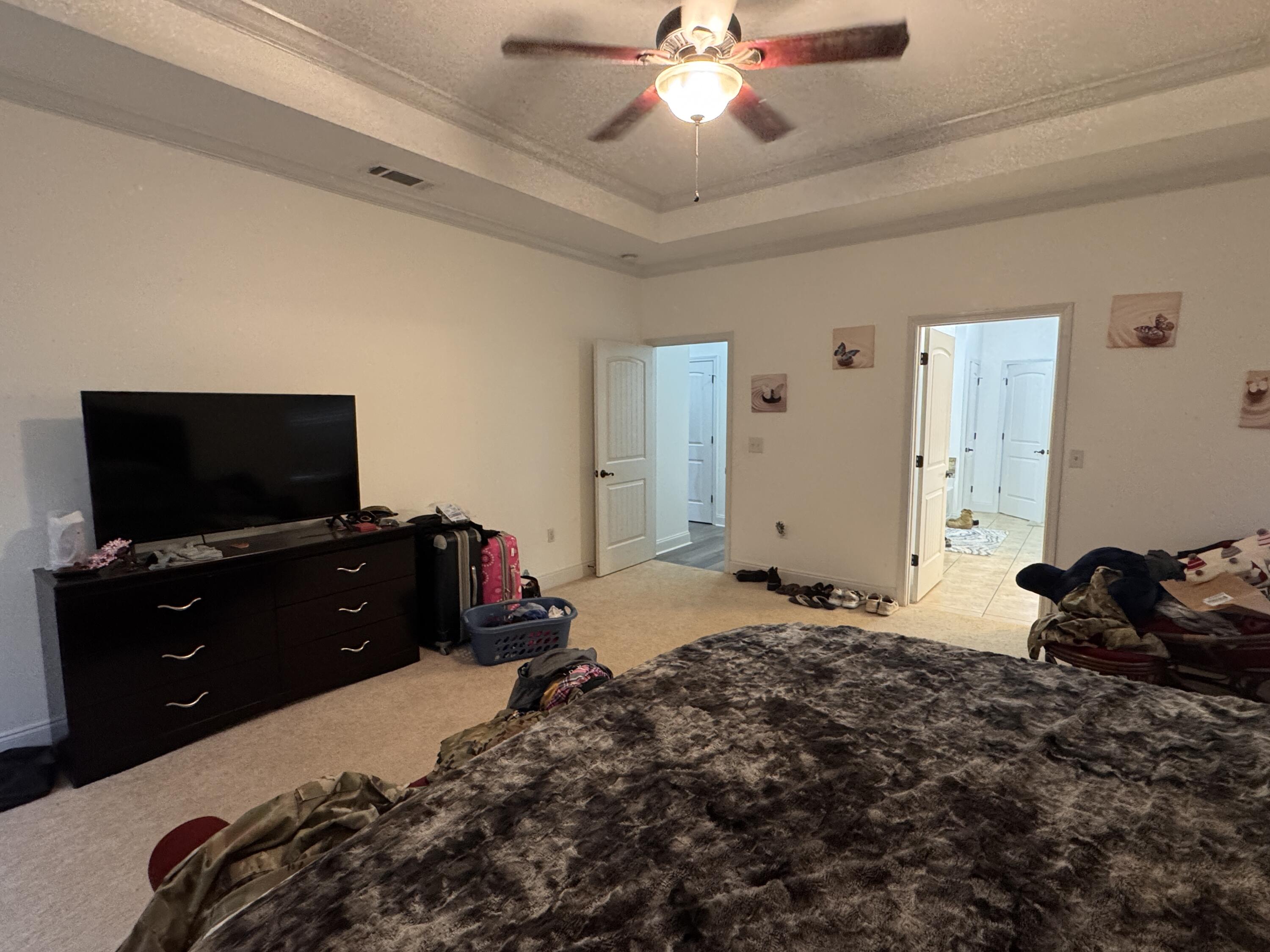 4413 Mirada Way Crestview, FL 32539 - Photo 10 of 27 a bedroom with a bed and a flat screen tv