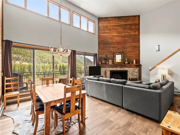 a dining room with furniture a fireplace and wooden floor