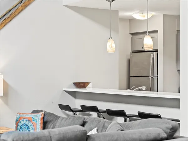 a living room with a couch and a chandelier