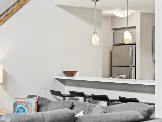 a living room with a couch and a chandelier