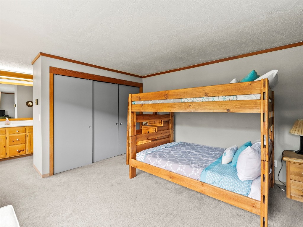 22320 Highway 6, Unit 1761 Keystone, CO 80435 - Photo 27 of 33 a bedroom with a bed and wooden floor