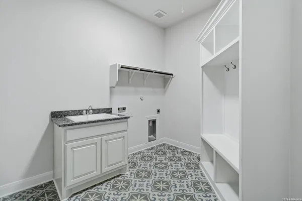 a utility room with sink dryer and washer
