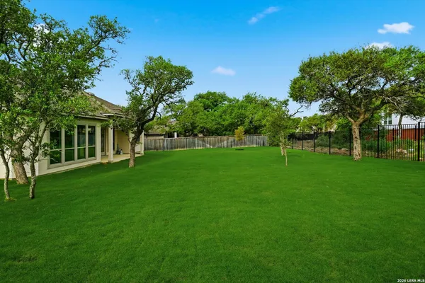 a view of yard with swimming pool and green space