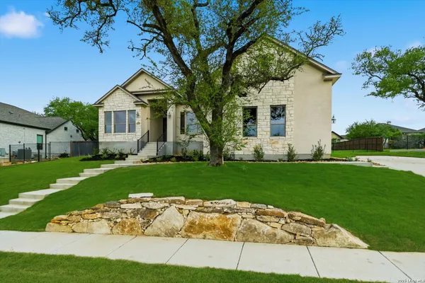 a front view of house with yard and green space