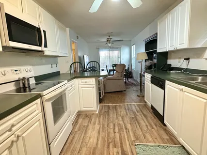 a kitchen with stainless steel appliances granite countertop a stove and a sink