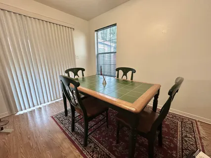 a view of a dining room with furniture and window