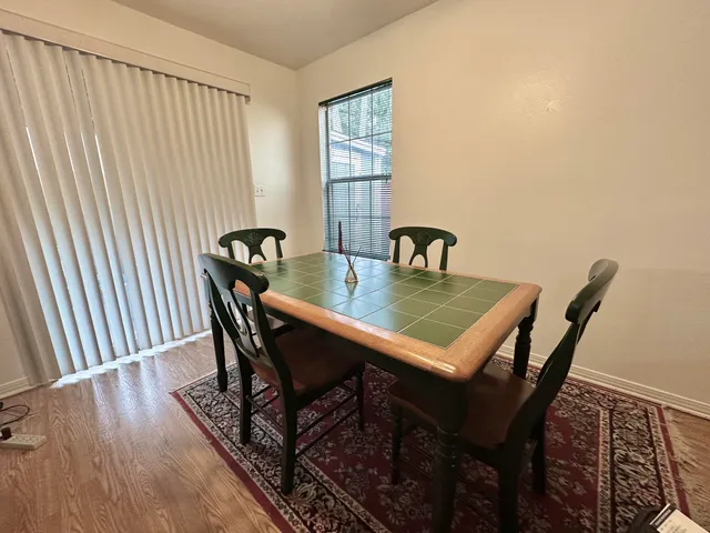 a view of a dining room with furniture and window