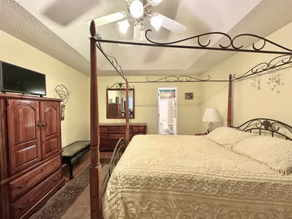 a bedroom with a bed and flat screen tv