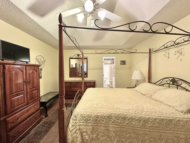 a bedroom with a bed and flat screen tv