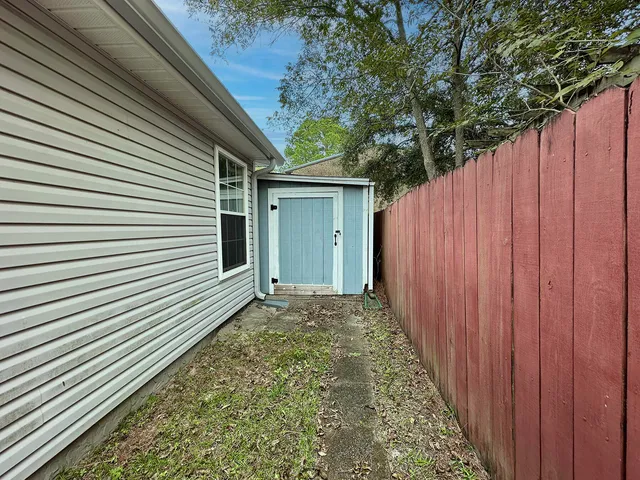 a view of a backyard with pathway