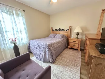 a bedroom with a bed and a couch