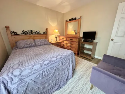 a bedroom with a bed and flat screen tv