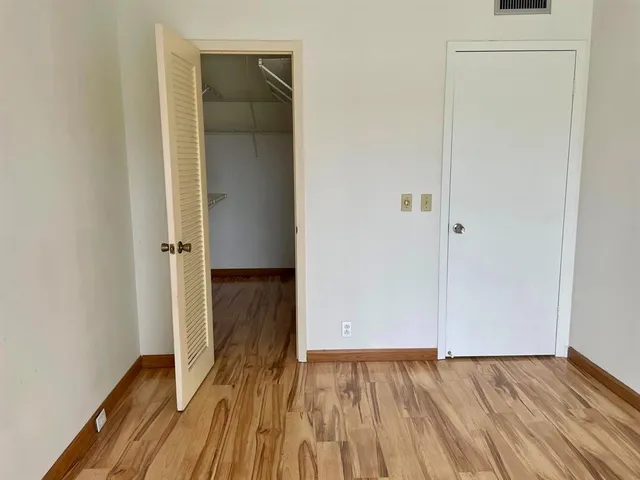a kitchen with cabinets stainless steel appliances a sink and a window
