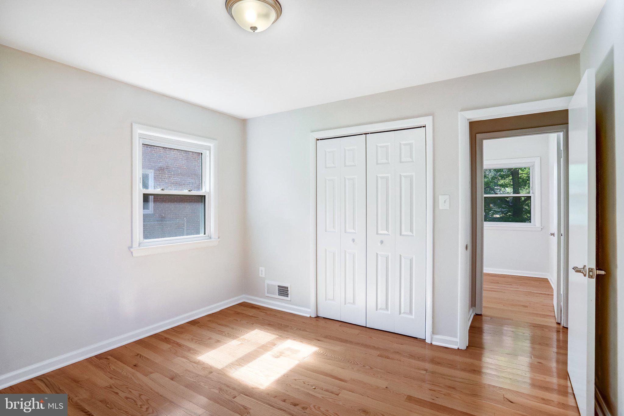616 Ritchie Avenue Silver Spring, MD 20910 - Photo 17 of 37 an empty room with wooden floor and windows