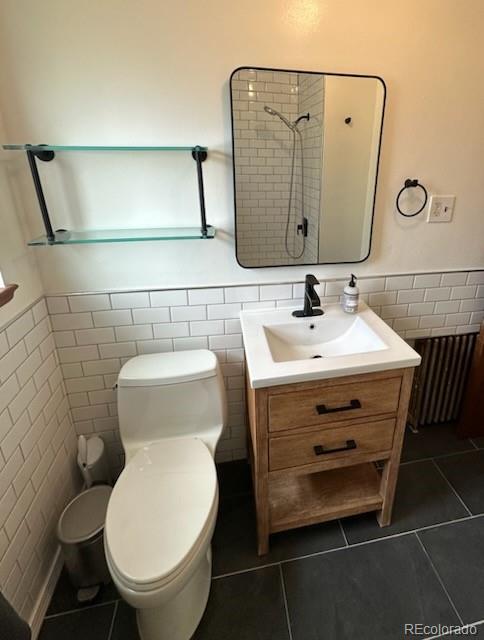 2050 Perry Street Denver, CO 80212 - Photo 7 of 15 a bathroom with a toilet sink and mirror