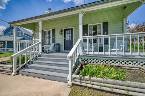 a view of a house with wooden fence
