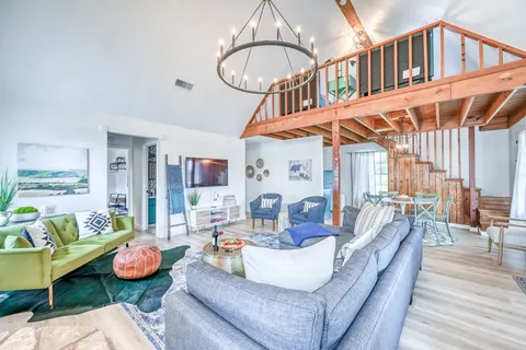 a living room with fireplace furniture and a large window