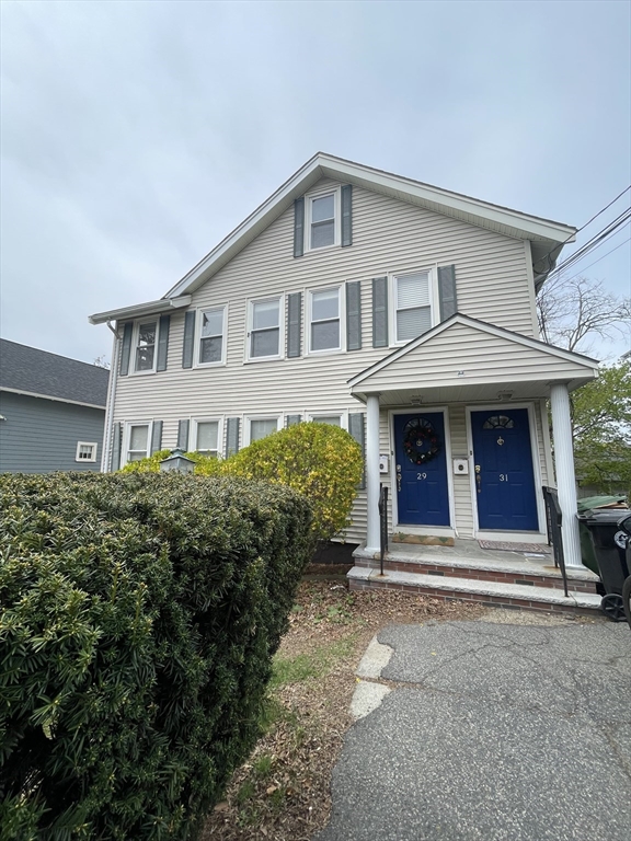 29-31 Bradford Road, Unit 31 Watertown, MA 02472 - Photo 2 of 11 a front view of a house with a garden